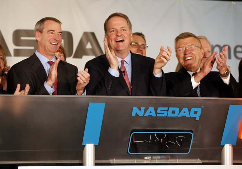 When American Airlines CEO Doug Parker (center) rang the opening bell for Nasdaq,...