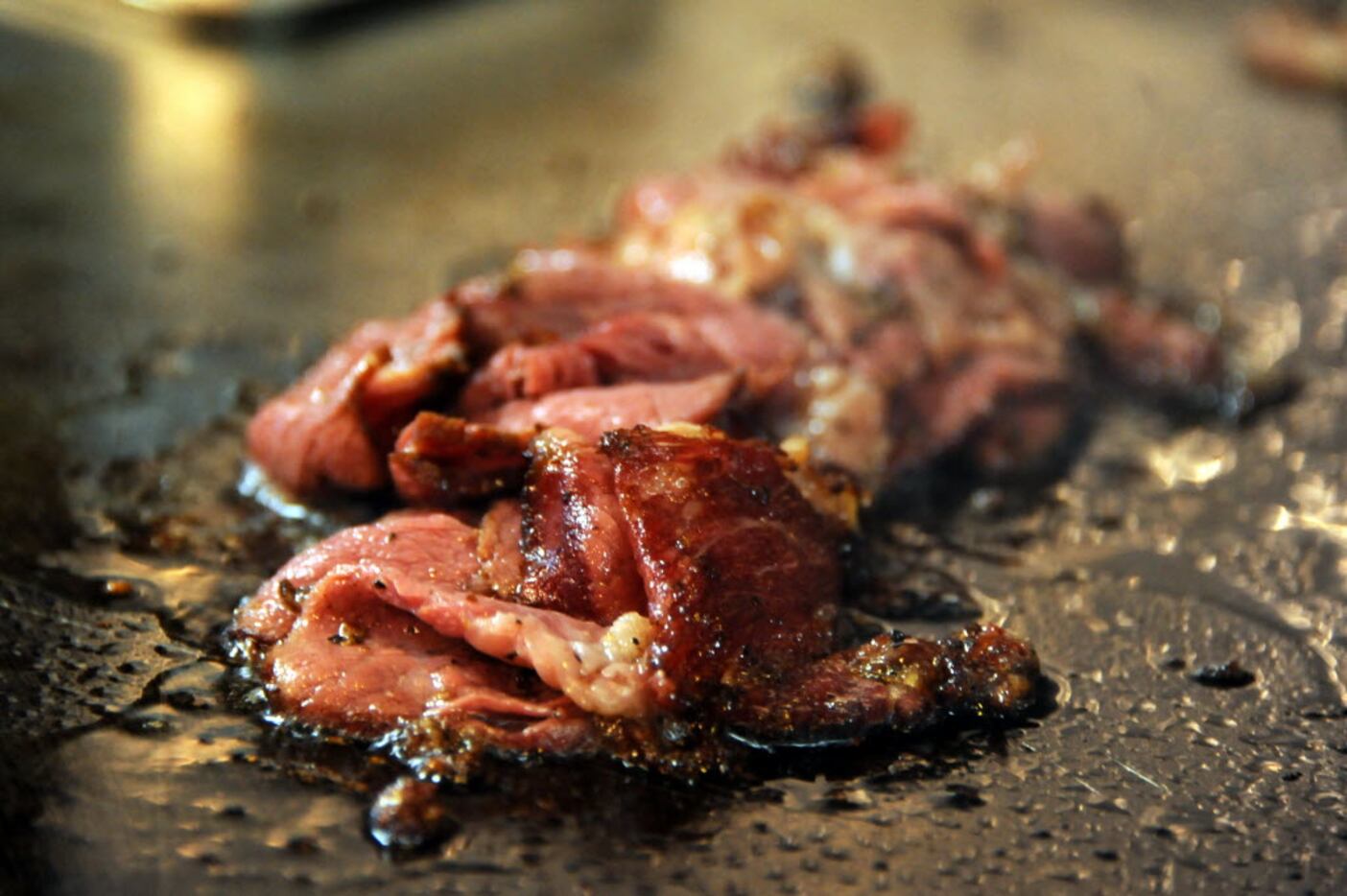 House-made pastrami sizzles on the grill at Goodfriend Package in Dallas, TX on January 13,...