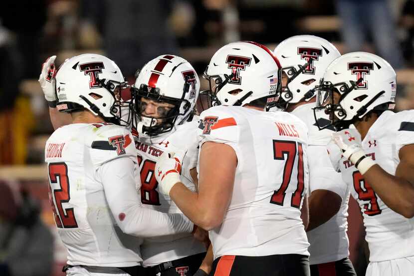 Texas Tech tight end Baylor Cupp, second from left, celebrates with teammates after catching...