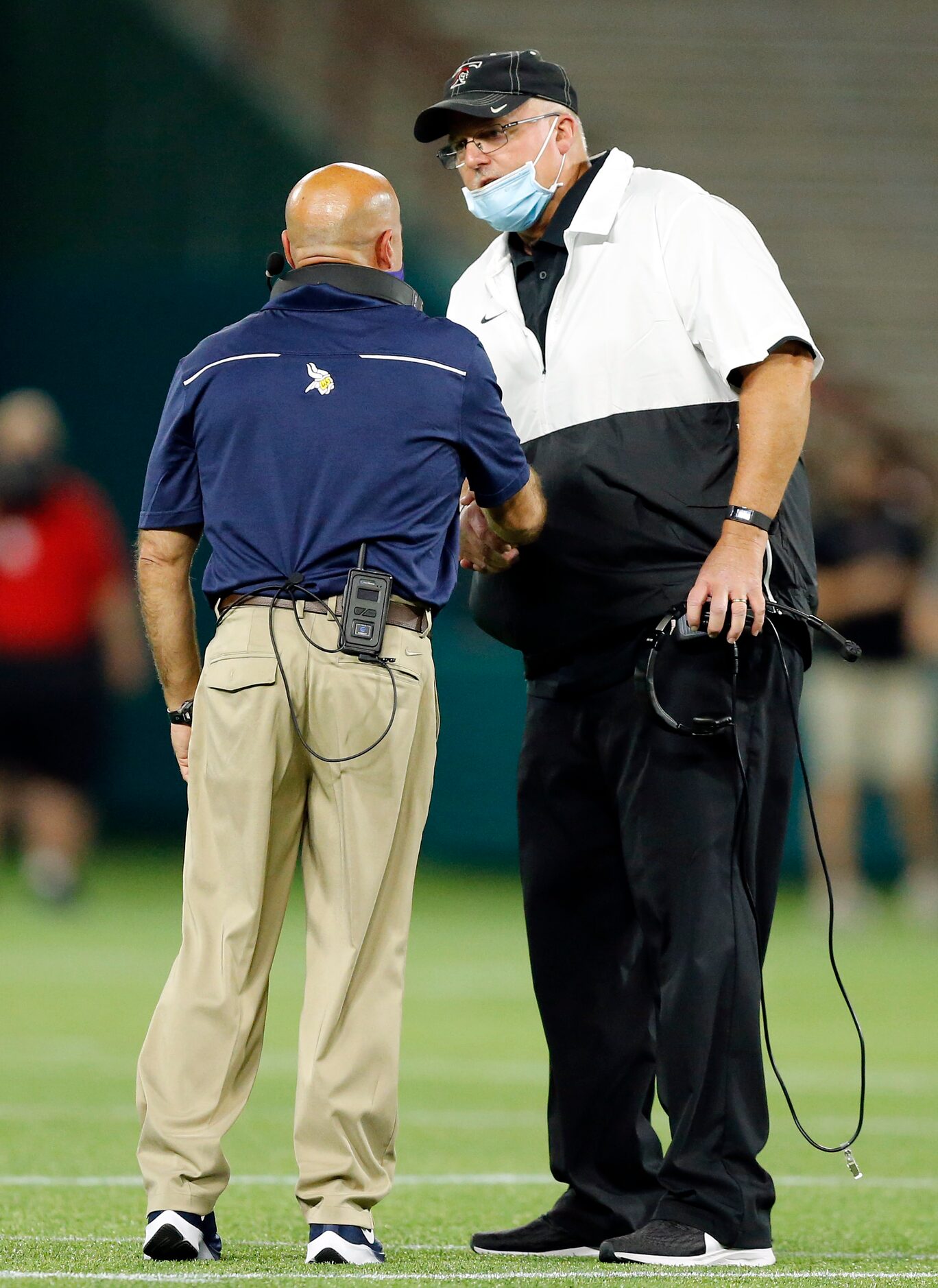 Arlington Lamar head coach Laban DeLay (let) and Euless Trinity head coach Chris Jensen...