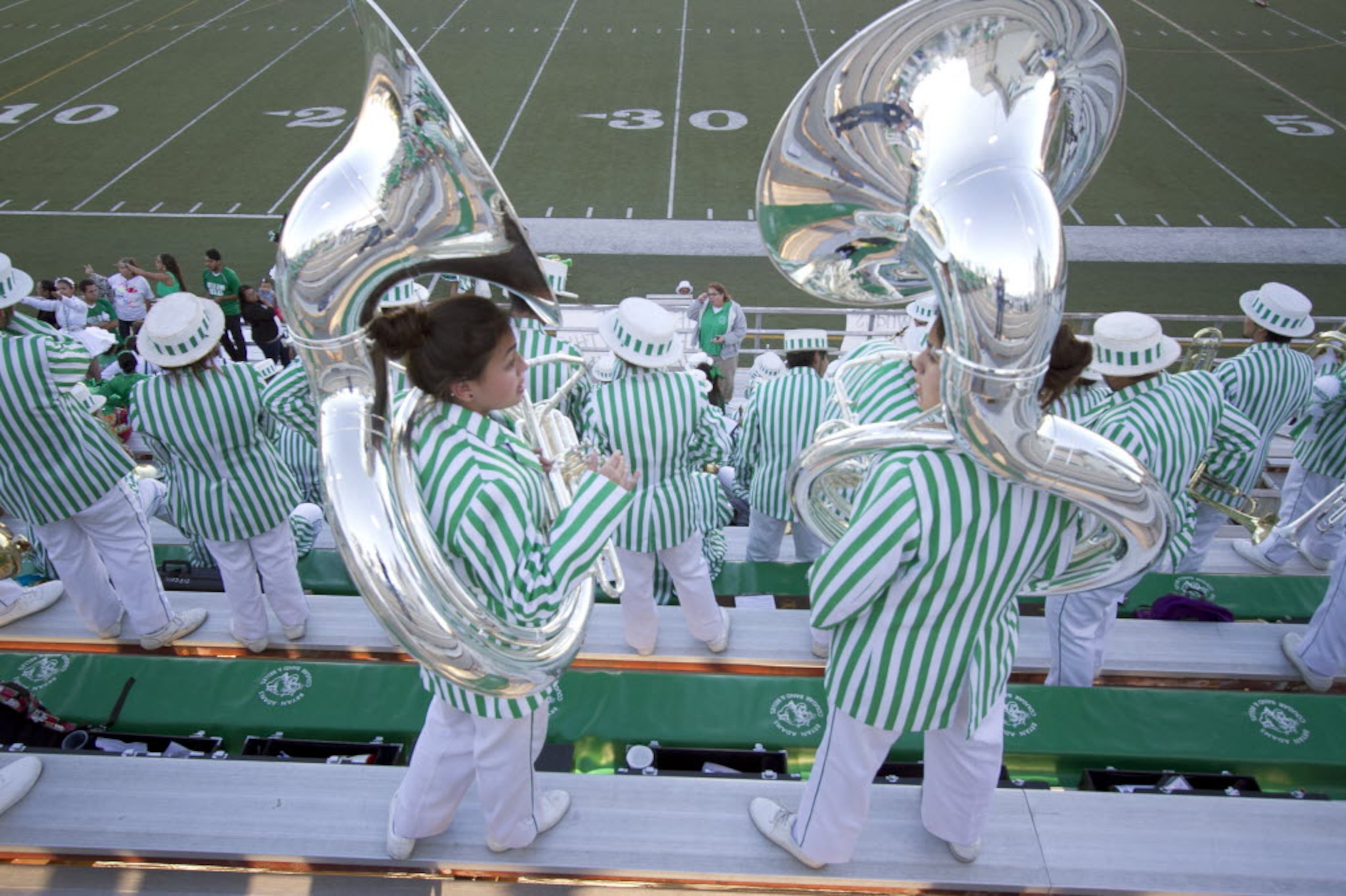 Ariel Moree and Jasmine Bermejo, both sophomore members of the Bryan Adams Cougar band, give...