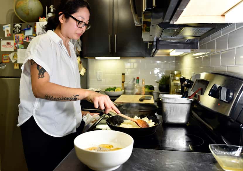 Chef Angela Hernandez, 34, prepares a dish of potato with egg at her home in Dallas.