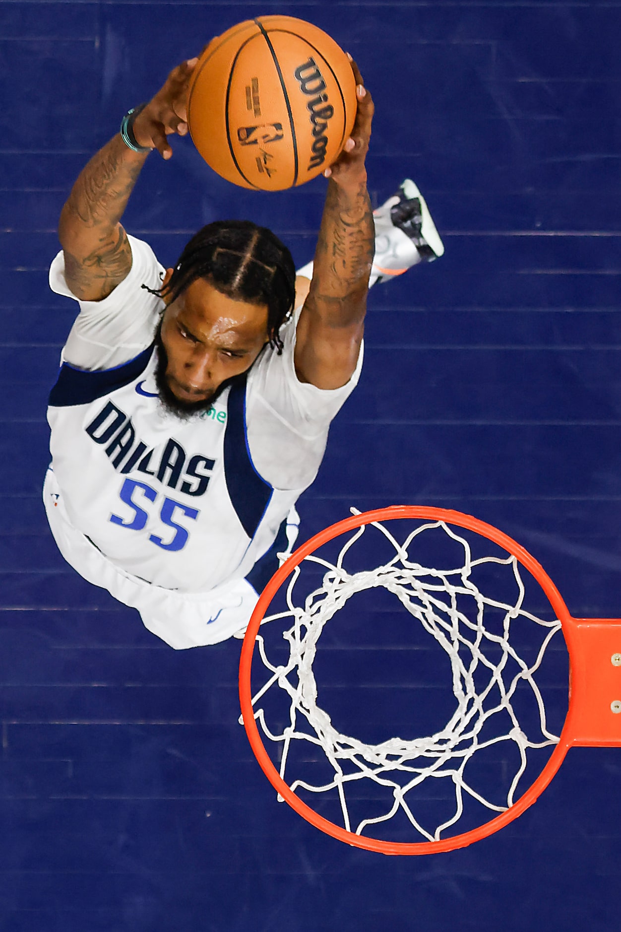 Dallas Mavericks forward Derrick Jones Jr. (55) reaches for an alley-oop from guard Luka...