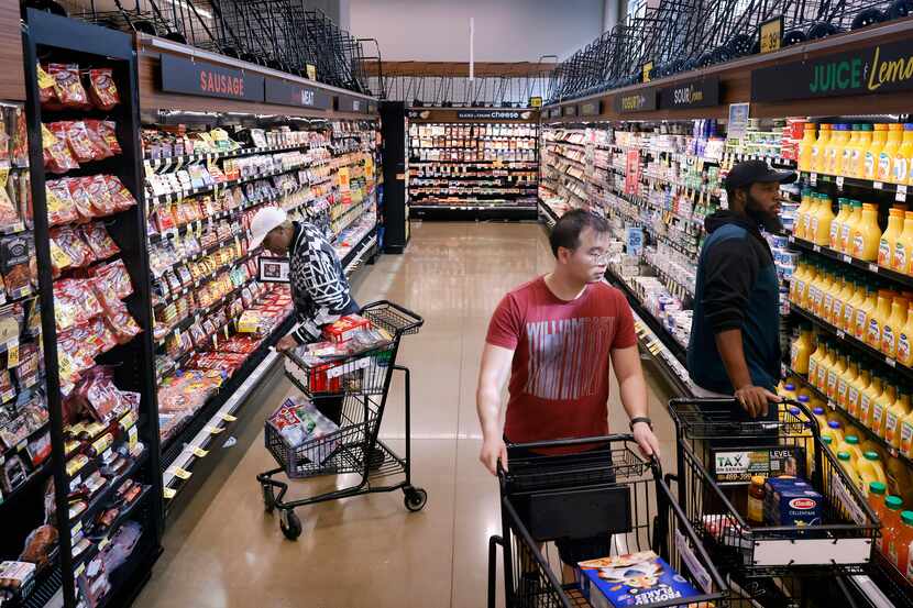 Shoppers peruse the aisles of the Tom Thumb grocery store on Live Oak Street, just east of...