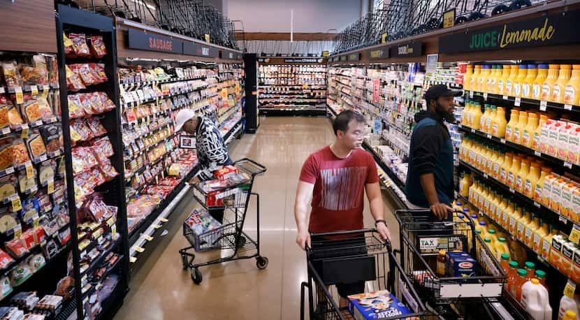 Shoppers peruse the aisles of the Tom Thumb grocery store on Live Oak Street just east of...