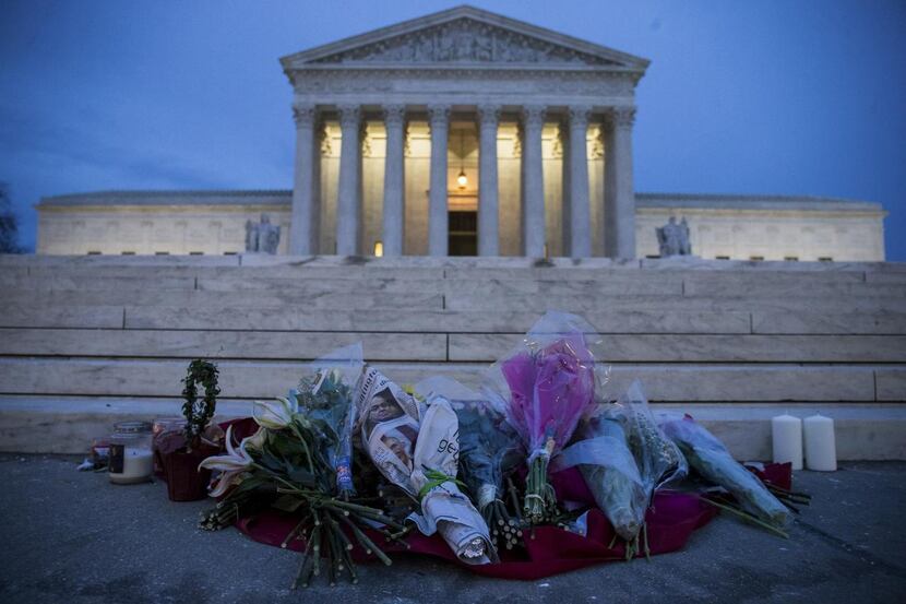 
A makeshift memorial, shown Sunday outside the Supreme Court in Washington, was set up to...
