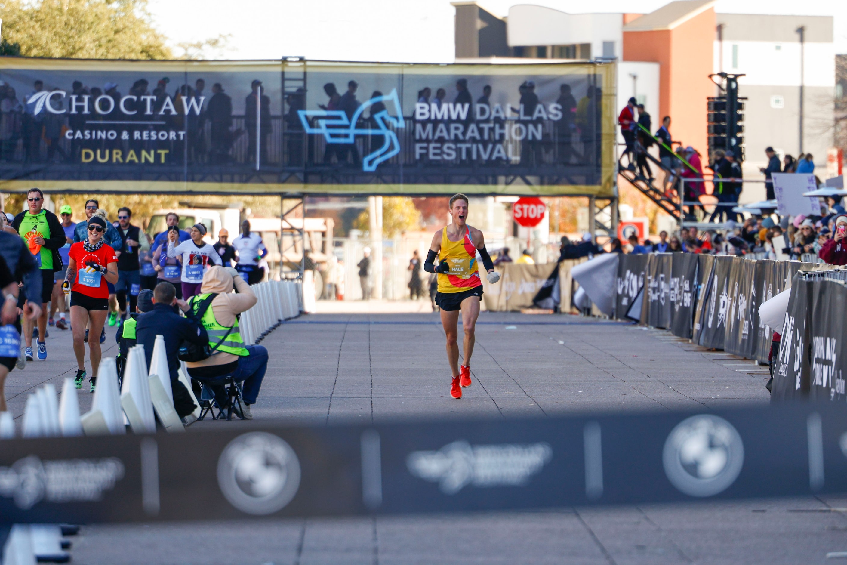 Men’s marathon finisher Joseph Hale, 30, of Grapevine, celebrates ahead of reaching the...