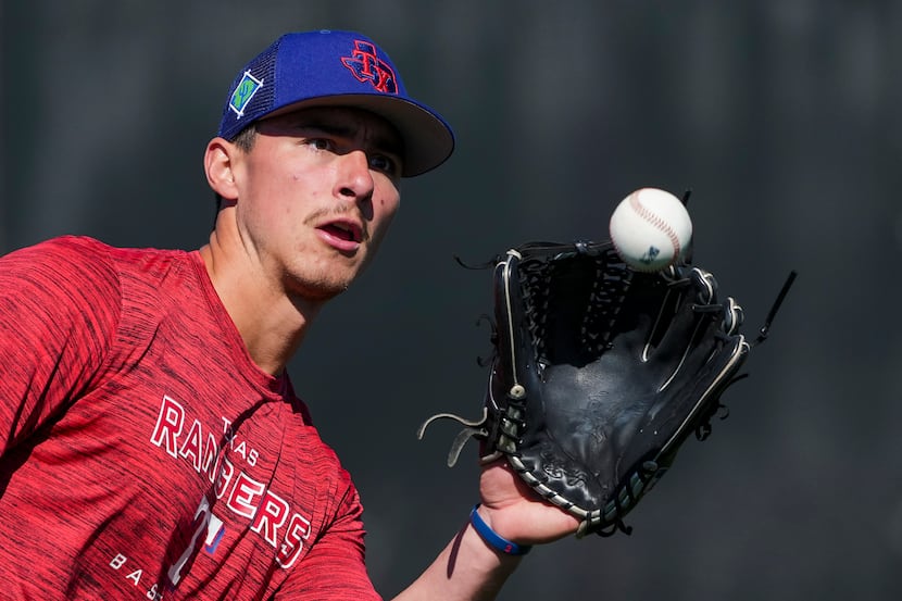 Outfielder Aaron Zavala participates in a defensive drill during a Texas Rangers minor...