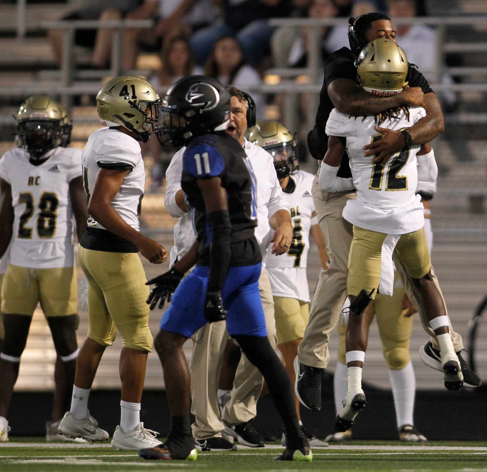 Royse City defensive back Mikolas Bolton (12) celebrates with an assistant coach after his...