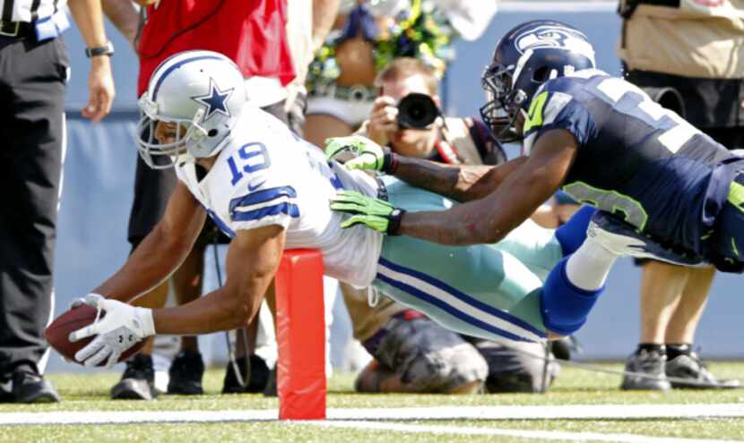 Dallas Cowboys wide receiver Miles Austin (19) dives for a touchdown in front of Seattle...