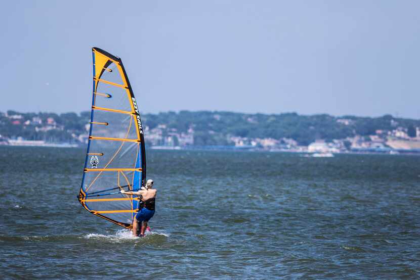 A man windsurfs at Windsurf Bay Park, at Lake Ray Hubbard in Garland. (Carly Geraci/The...