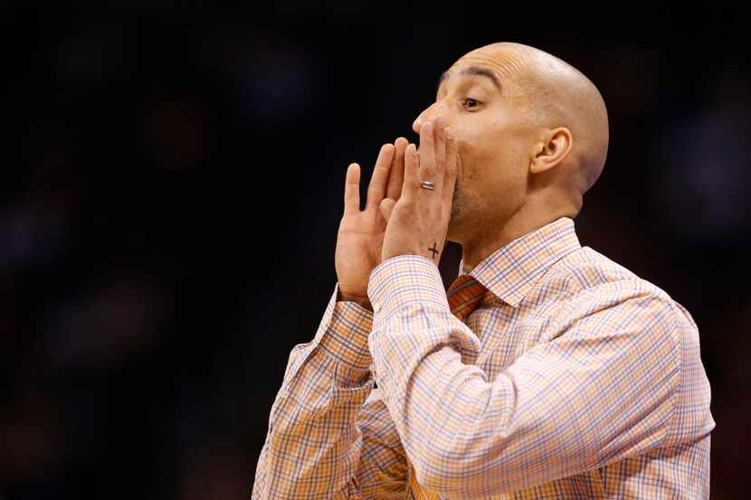 Texas Longhorns head coach Shaka Smart communicates to his players in a game against the...