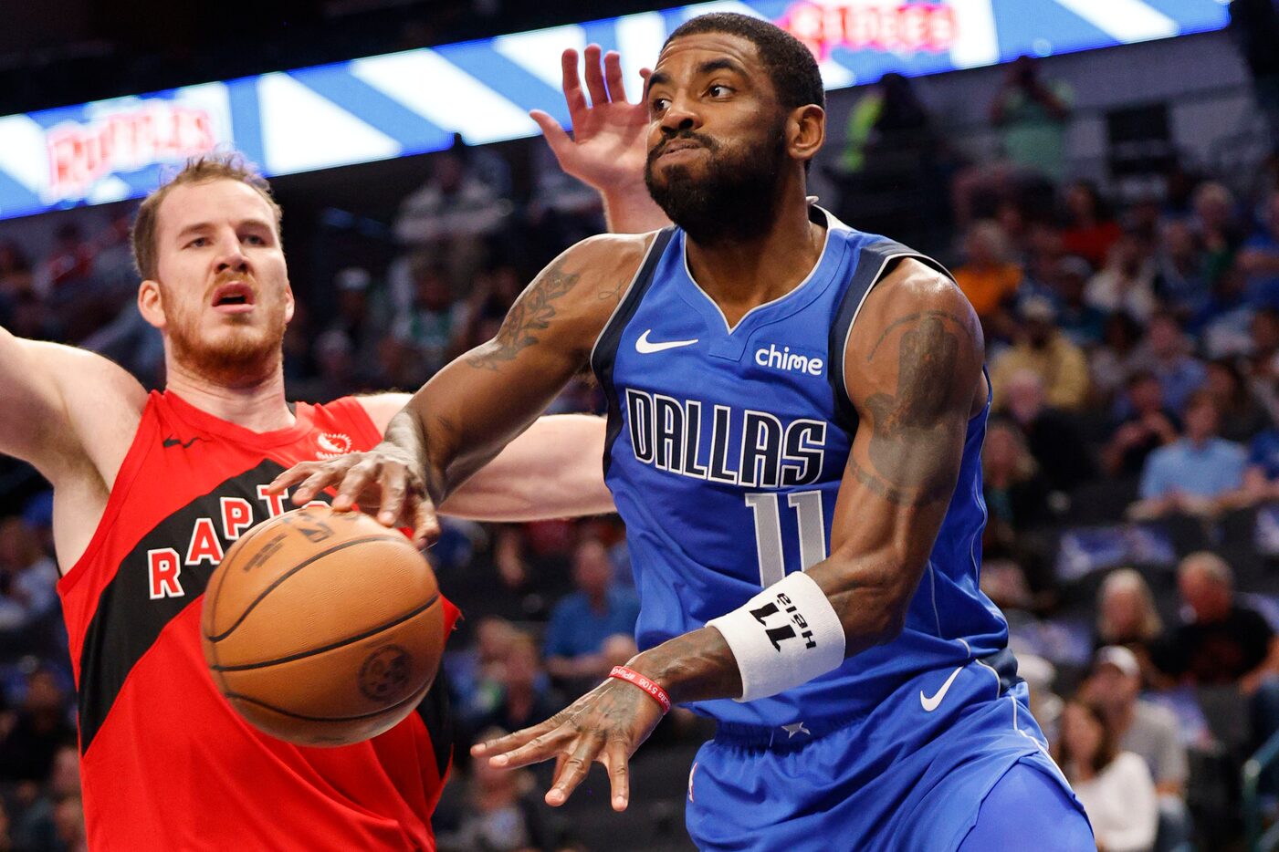 Dallas Mavericks guard Kyrie Irving (11) shoots over Toronto Raptors center Jakob Poeltl...