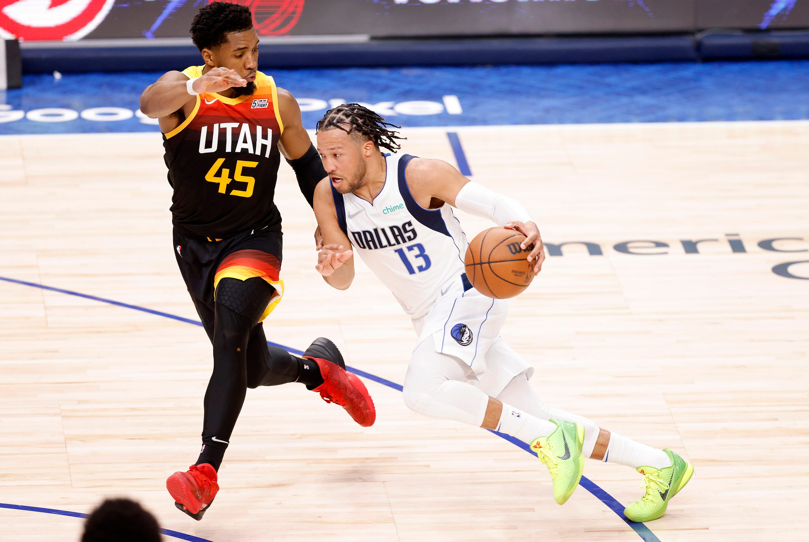 Dallas Mavericks guard Jalen Brunson (13) drives past Utah Jazz guard Donovan Mitchell (45)...