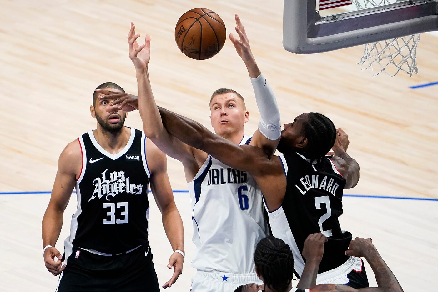 Dallas Mavericks center Kristaps Porzingis (6) fight for a rebound against LA Clippers...