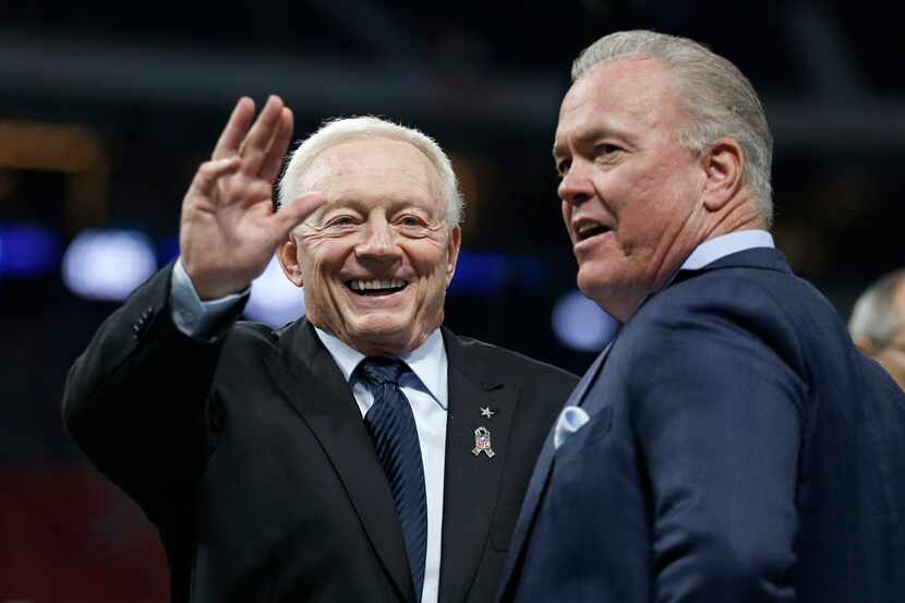 Dallas Cowboys owner Jerry Jones (left) visits with his son Stephen Jones before their game...
