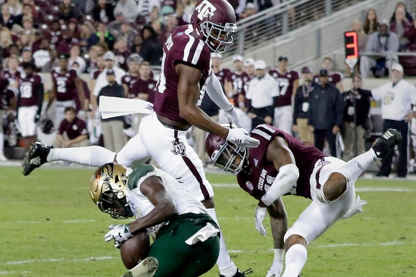 FILE - UAB wide receiver Kailon Carter, left, makes the catch under pressure from Texas A&M...