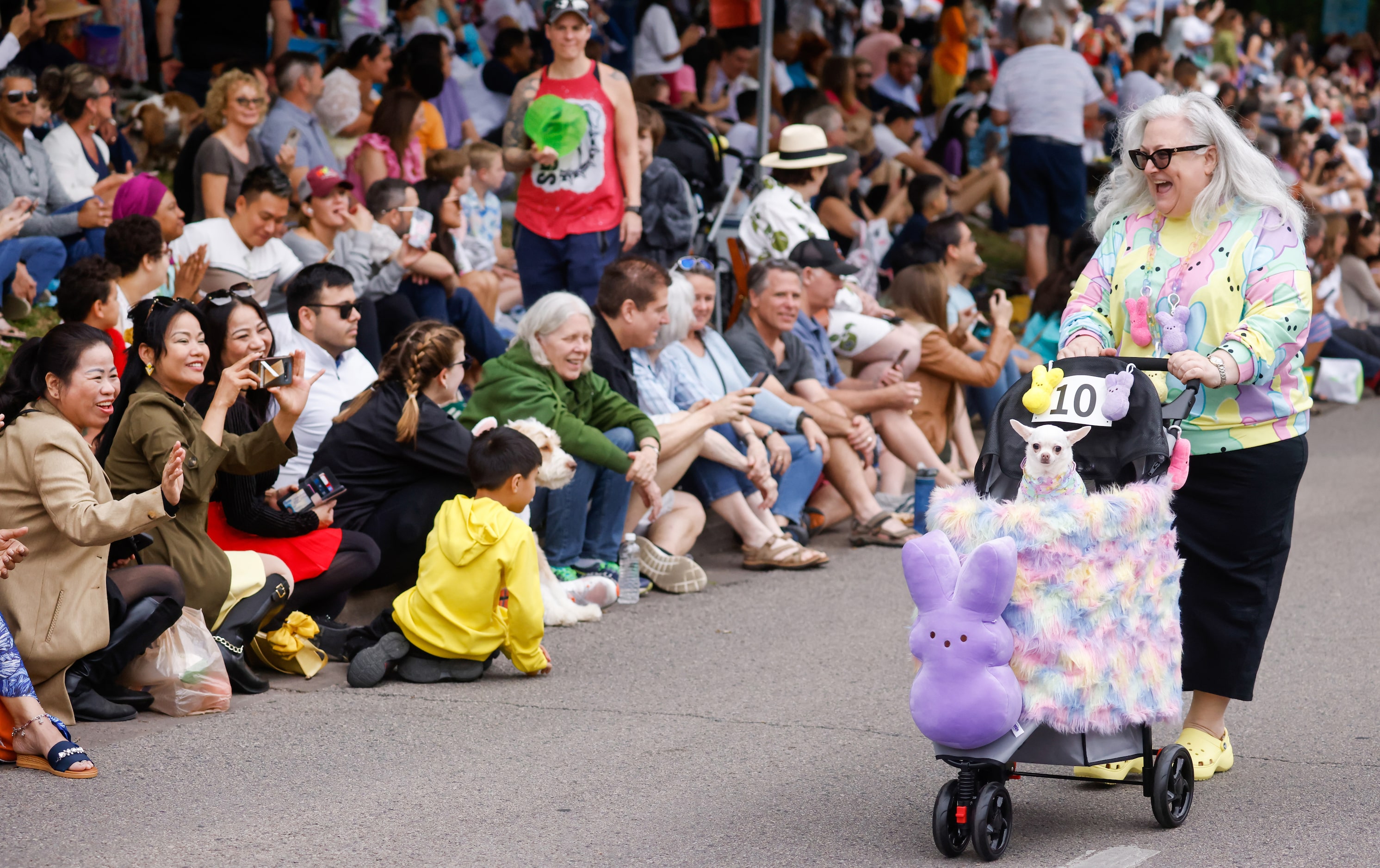 Wendy Golman (right) pushes Paloma, 8, down Turtle Creek Boulevard in the Pooch Parade at...