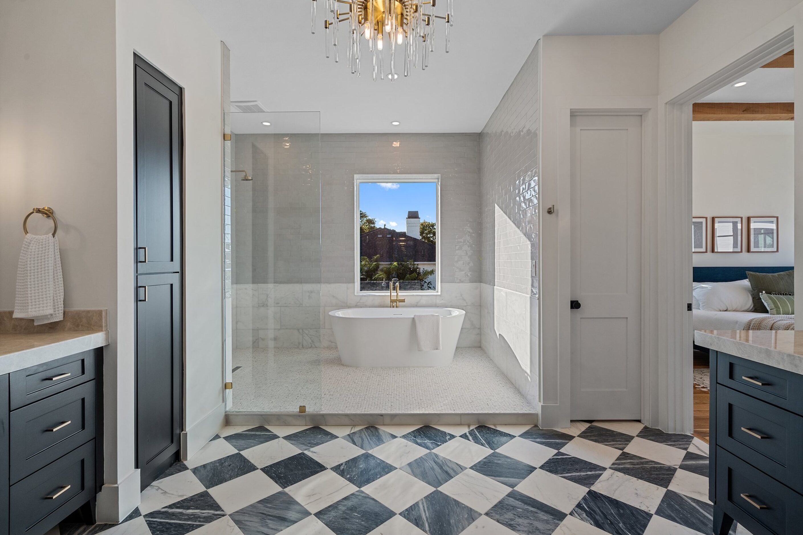 The black-and-white tile in the primary bathroom blends beautifully with the cabinetry. A...