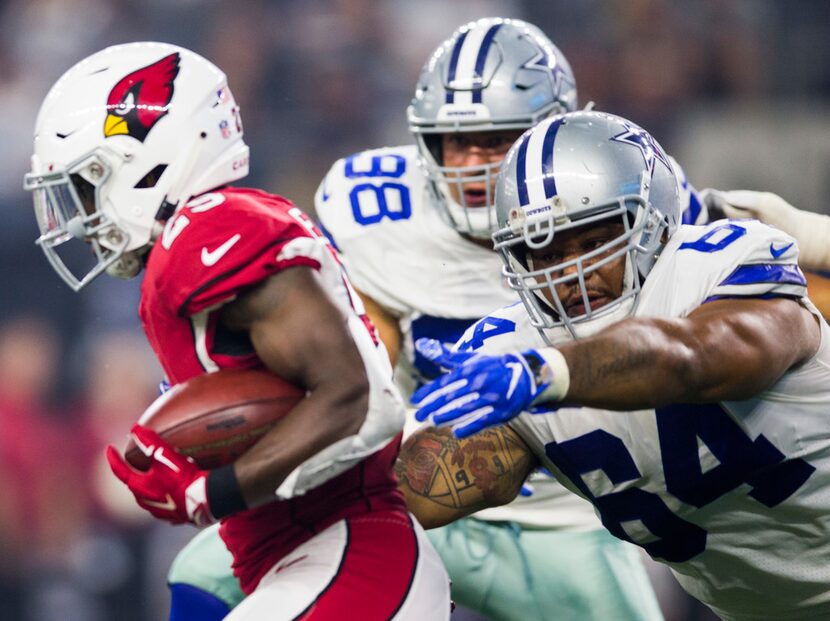 Dallas Cowboys nose tackle Antwaun Woods (64) tackles Arizona Cardinals cornerback Jonathan...