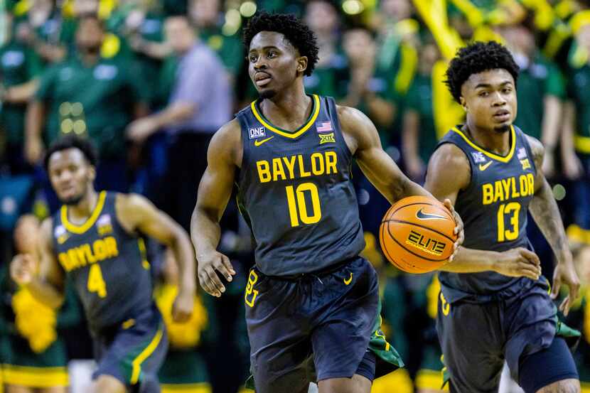 Baylor guards Adam Flagler (10) and Langston Love (13) run together down the court during...