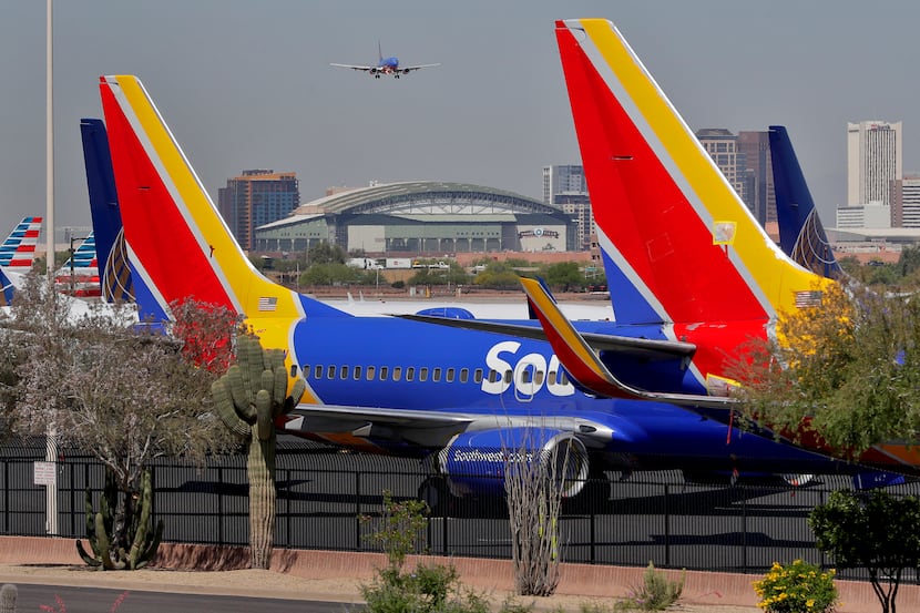 A Southwest airlines jet making its final approach backdrops stored at Southwest jets at Sky...