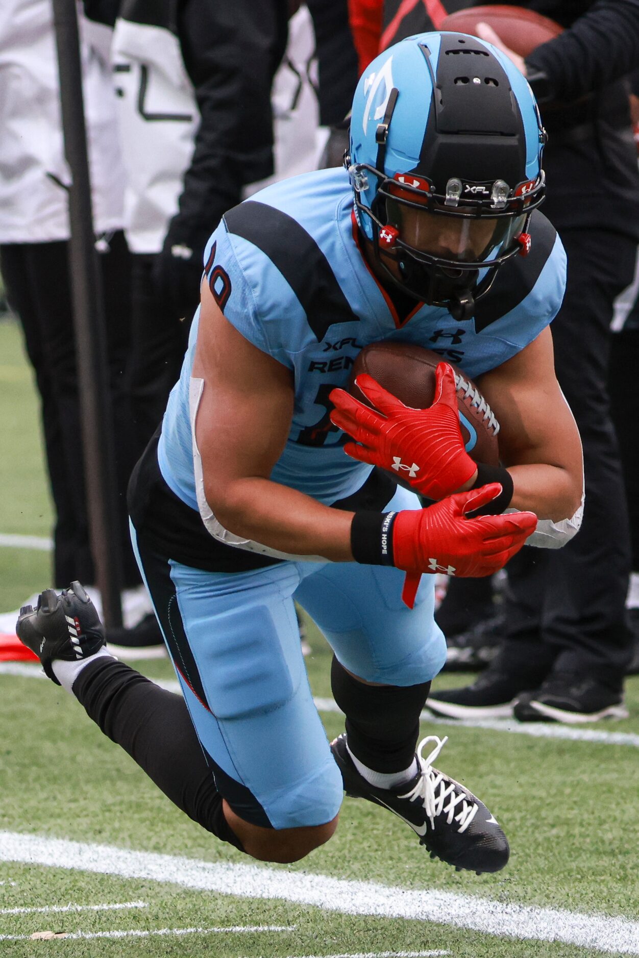 Arlington Renegades wide receiver Brandon Arconado (19) dives with the ball to gain yards up...