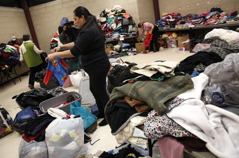 Mireya Flores sifted  through donated clothing Monday at Gale Fields Recreation Center in...