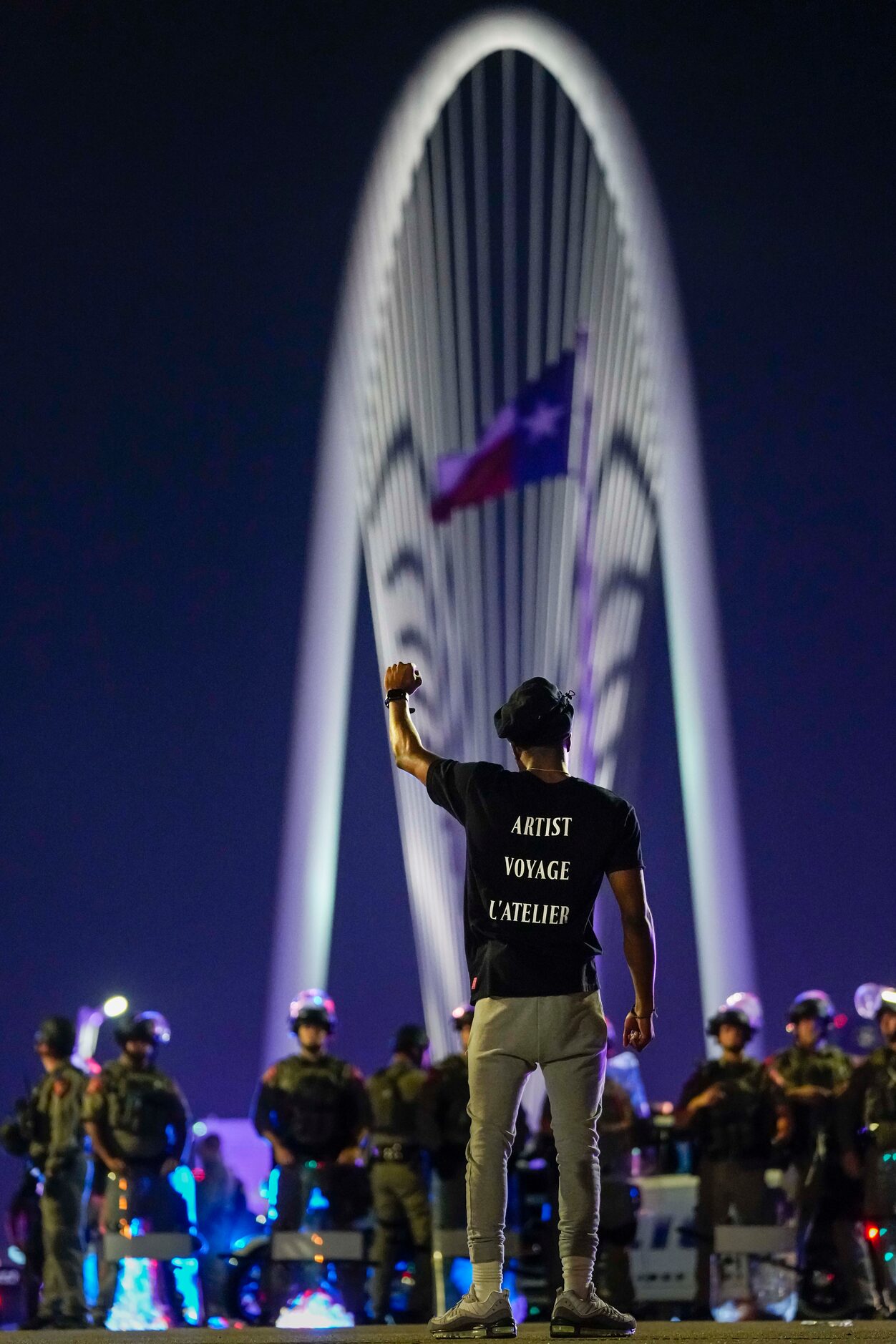 Demonstrator Devante Williamson stands in the middle of the street in solidarity as law...