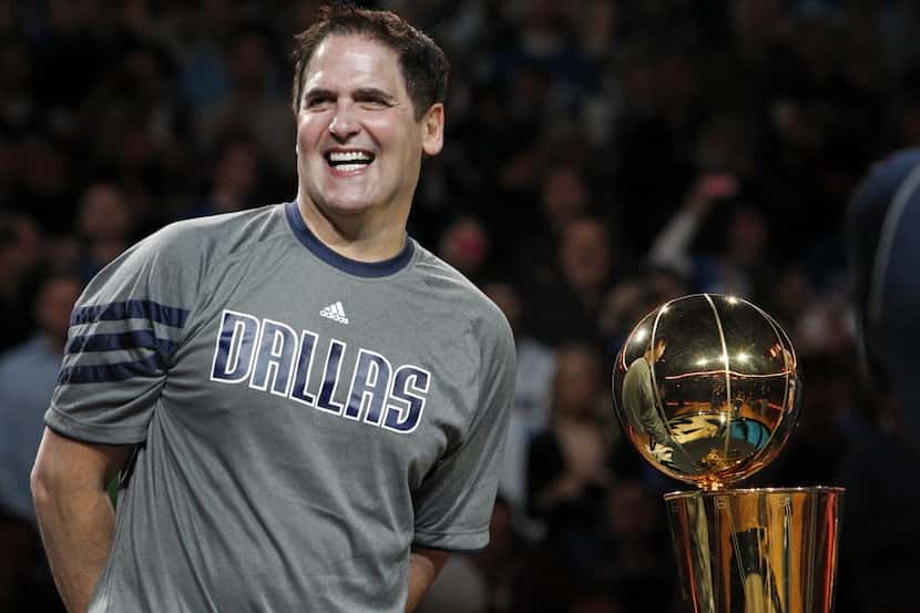 Dallas owner Mark Cuban stands by the Larry O'Brien trophy before the Miami Heat vs. the...