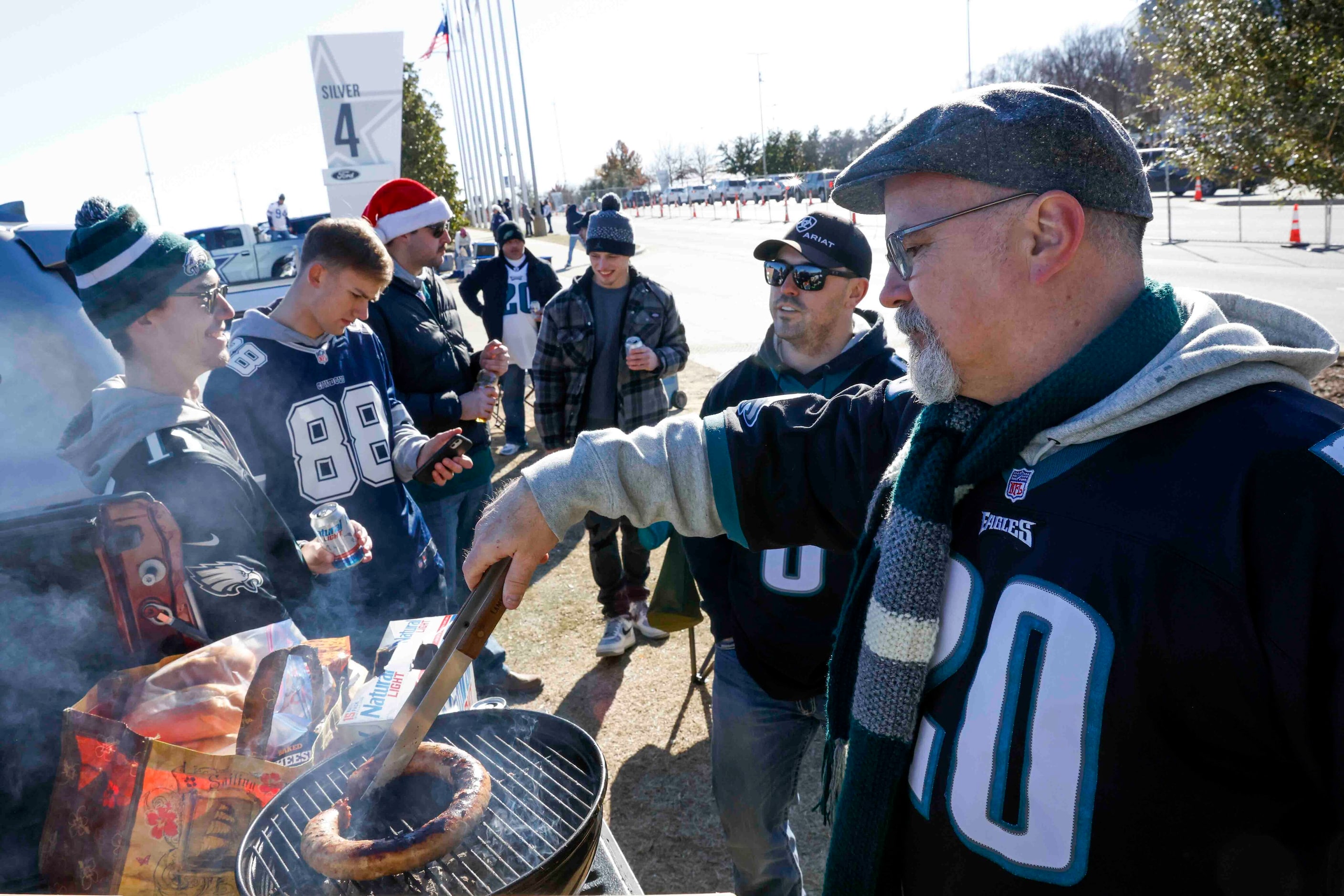 Tom Campbell, right, of Austin barbecues ahead of a NFL game between Dallas Cowboys and...