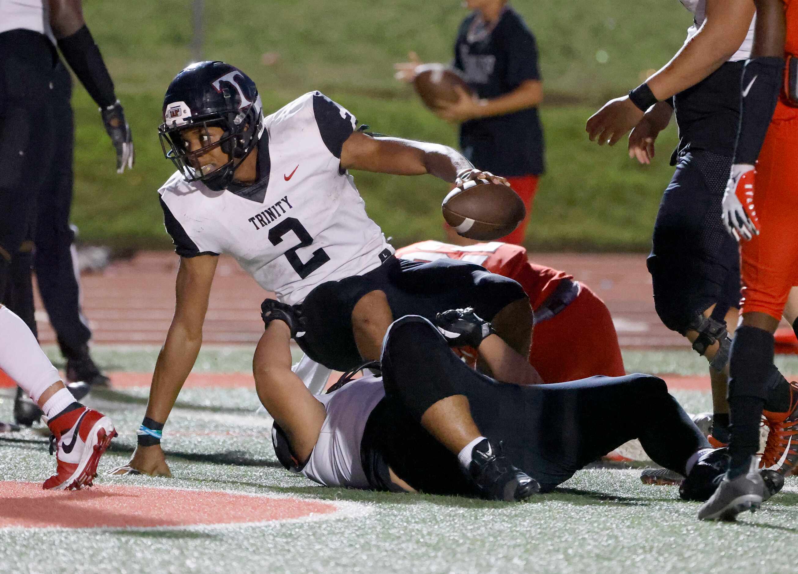 Euless Trinity quarterback Ollie Gordon (2) scores a rushing touchdown against Colleyville...