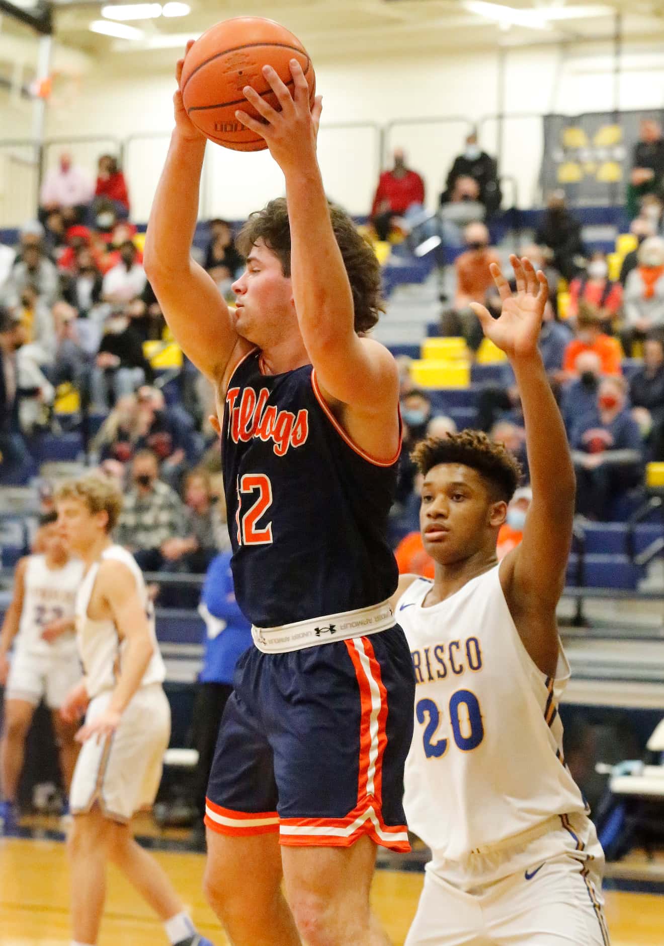 McKinney North High School post Dylan Frazier (12) pulls in a pass in front of Frisco High...