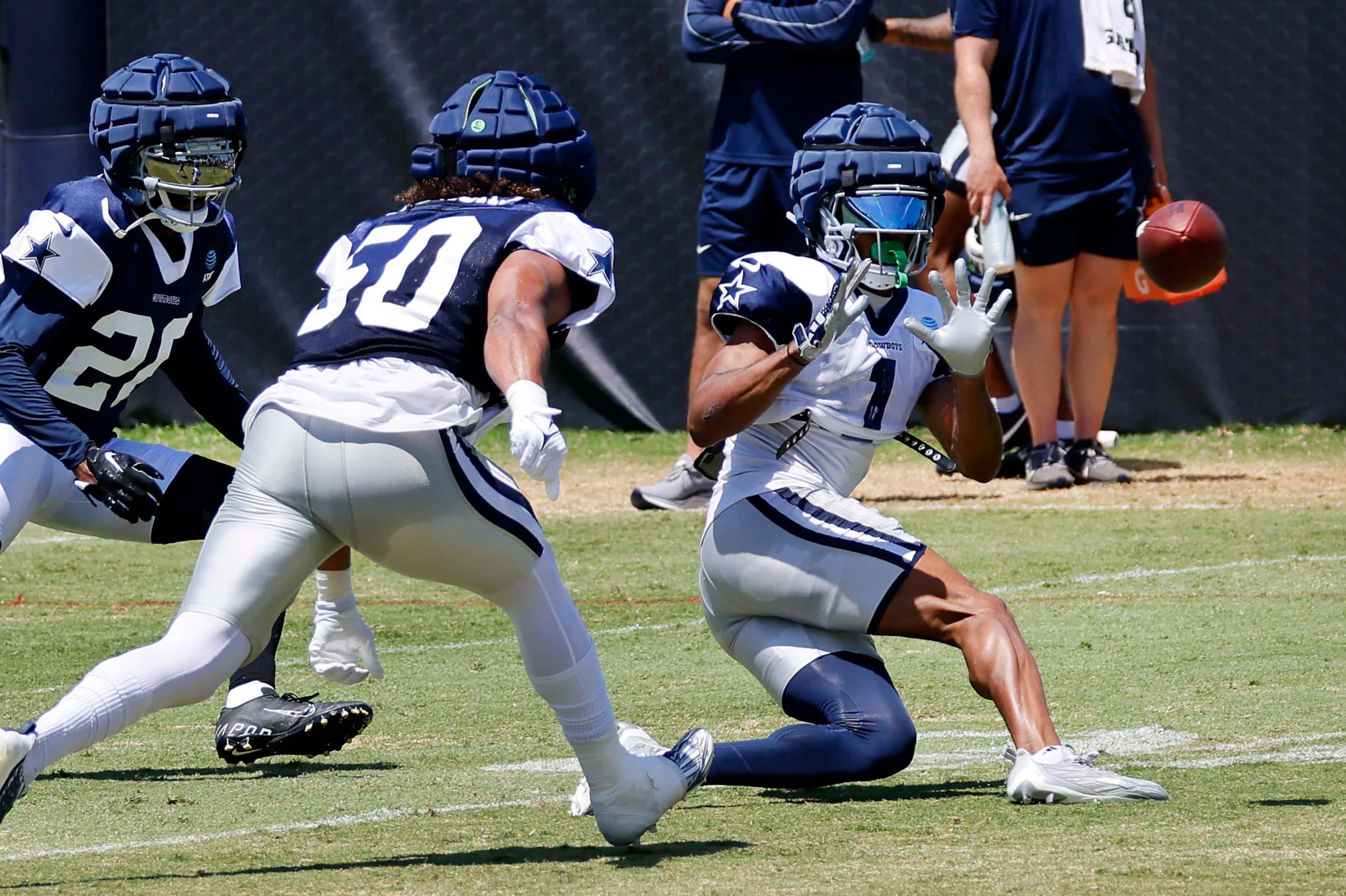 Dallas Cowboys wide receiver Jalen Tolbert (1) makes a sliding catch in front of linebacker...