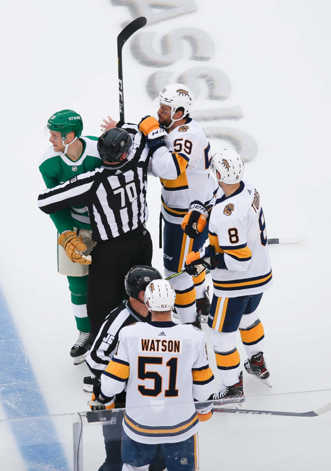 Linesman Derek Nansen (70) works to break up Dallas Stars right wing Corey Perry (10) and...