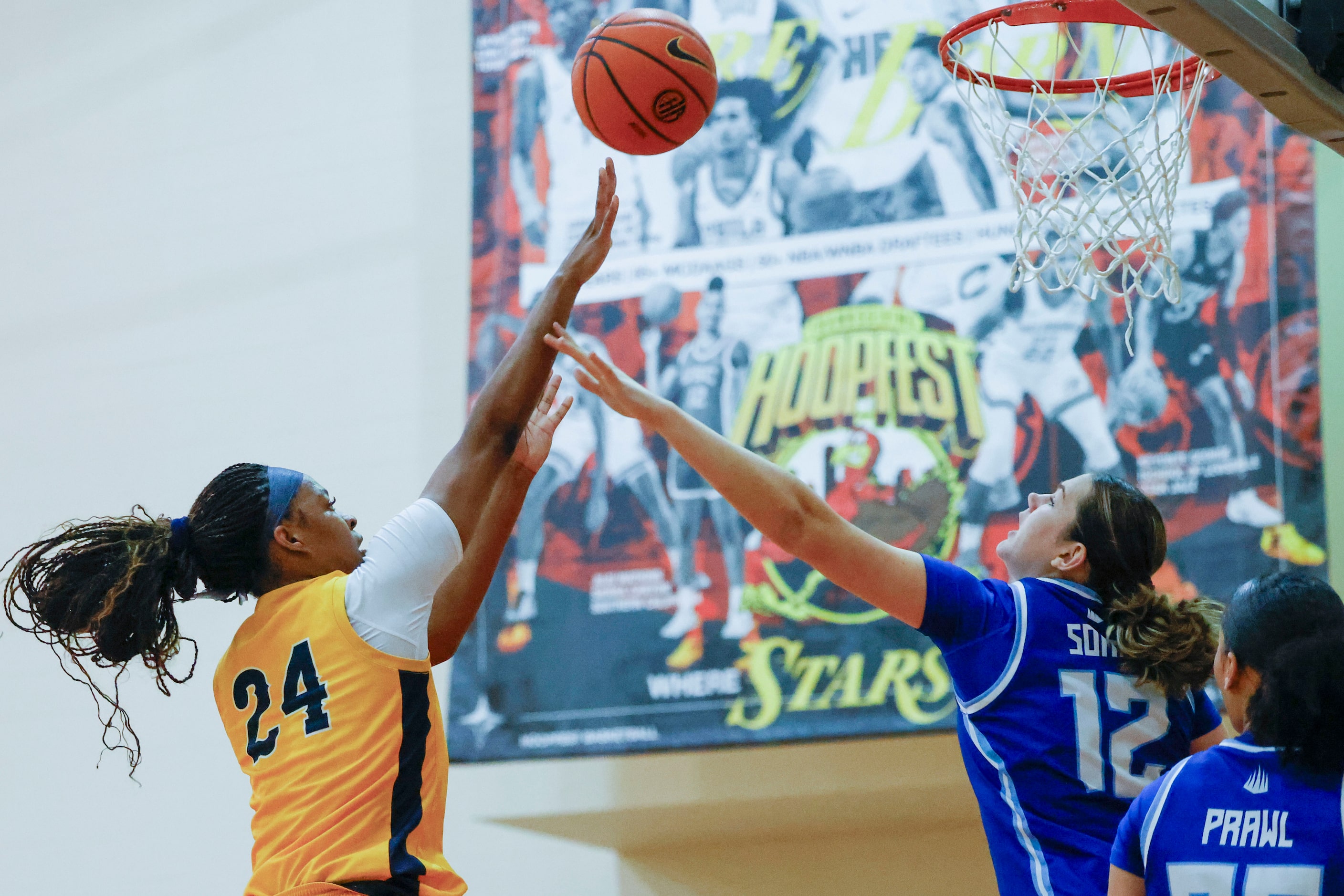 Oak Cliff Faith Family Academy’s Amari Byles (24) shoots over IMG Academy’s Lara Somfai...