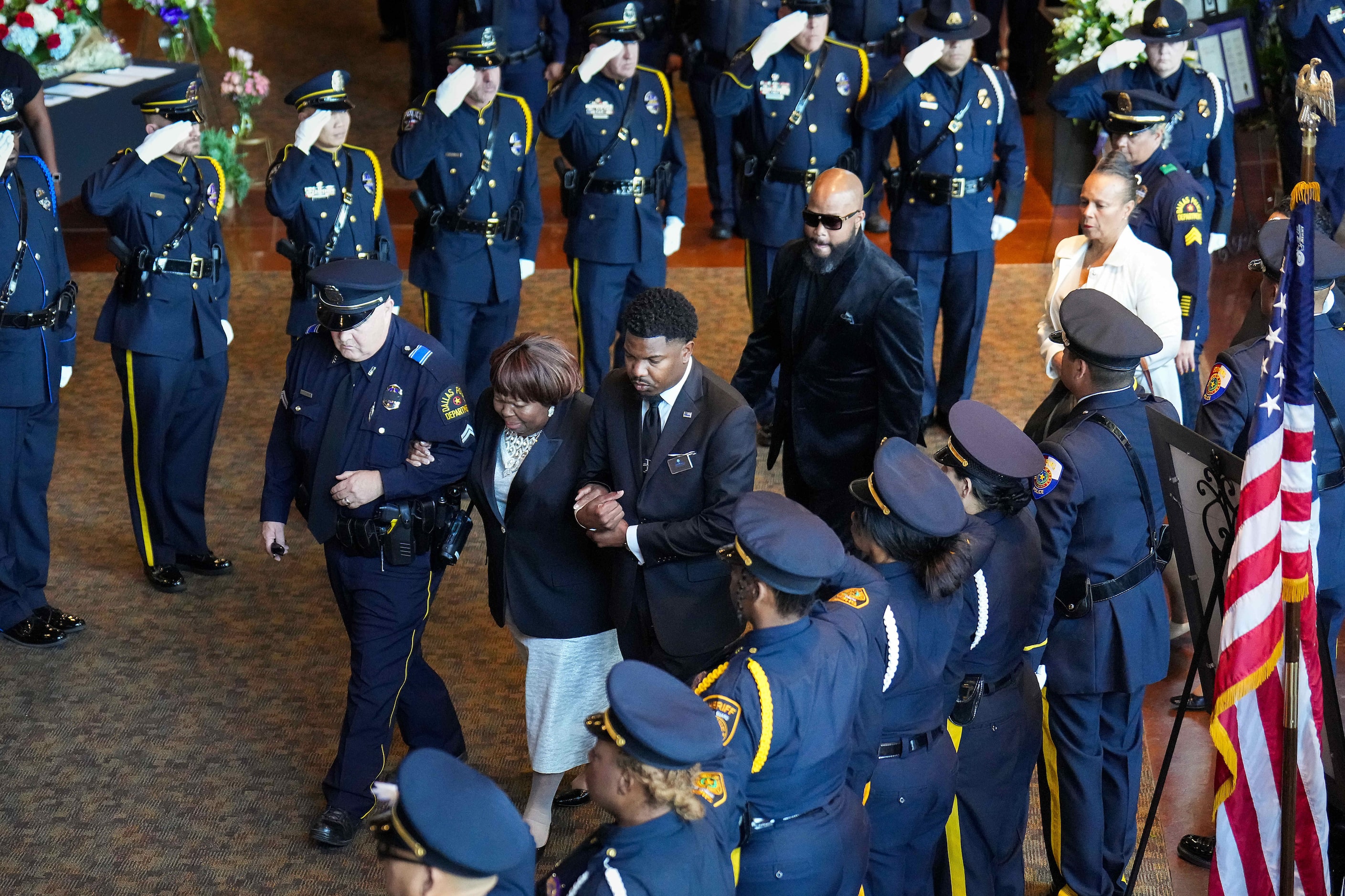 Cherie Jeffery is escorted in to the church through an honor guard comprised of multiple law...