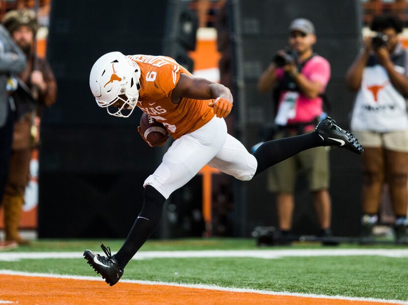 FILE - Texas wide receiver Devin Duvernay (6) scores a touchdown during the fourth quarter...