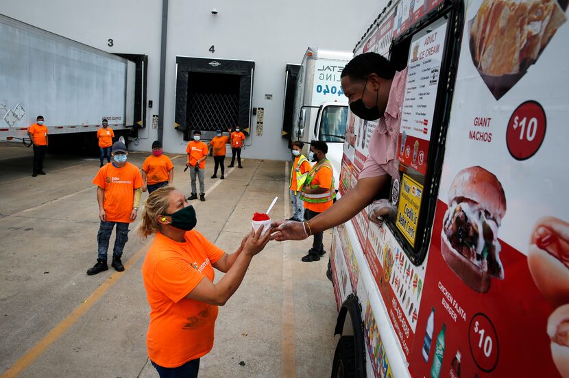 An Echo Environmental employee receives a sweet treat from from Mr. Sugar Ruch marketing...