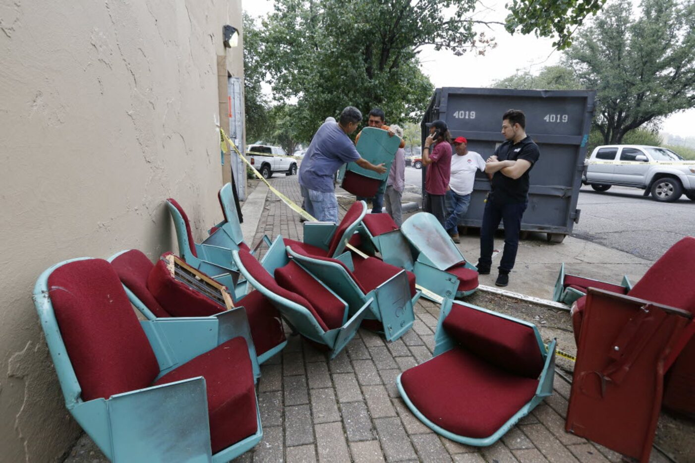 Lakewood Theater fans wait to take one or more of the many seats from workers at the...