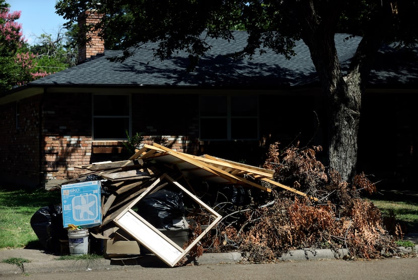 Storm debris is piled up at curbs in front of people's homes in the Buckner Terrace...