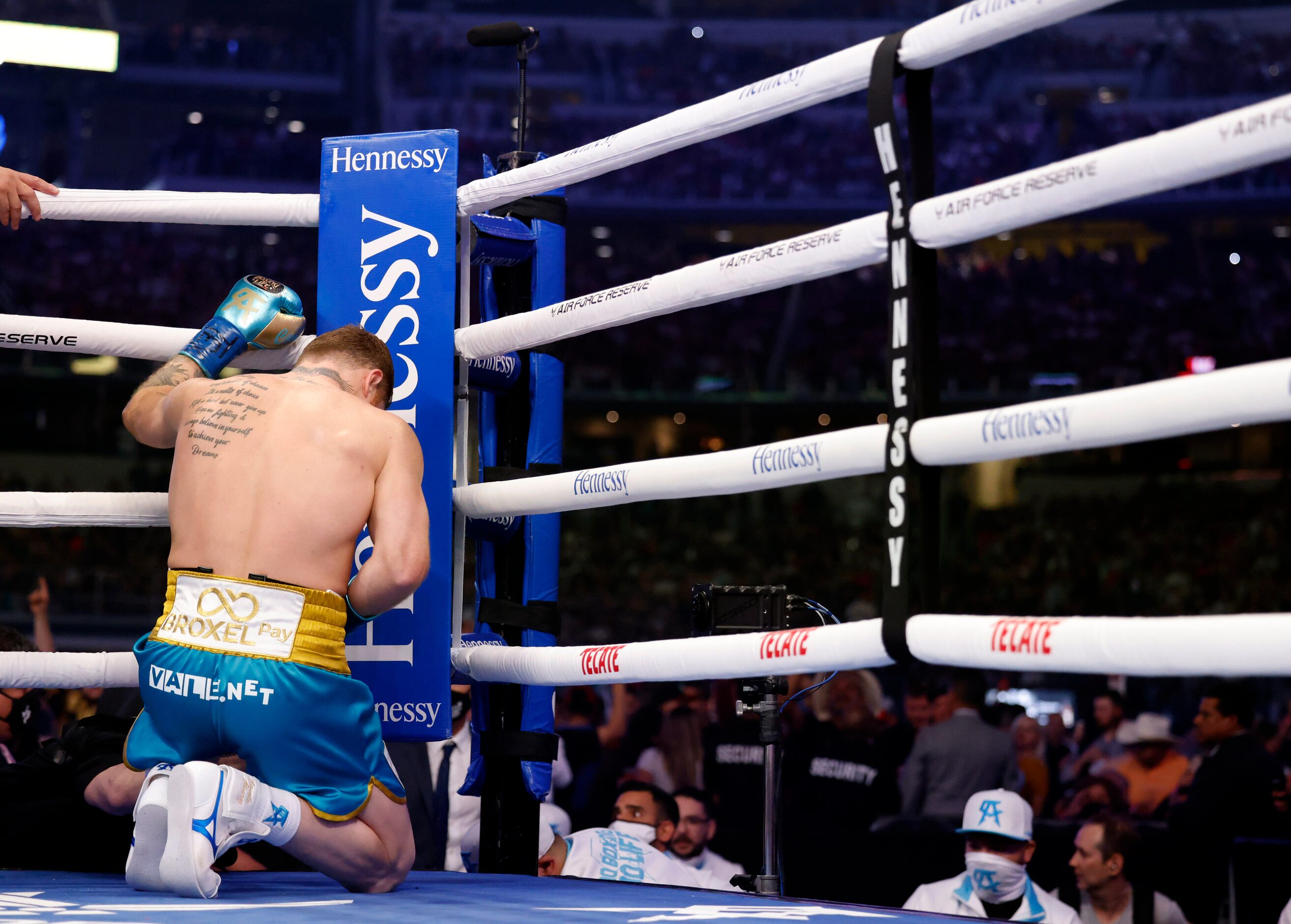 Boxer Canelo Alvarez kneels at his corner in prayer before fighting Billy Joe Saunders in...