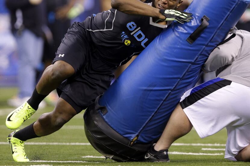 Missouri defensive lineman Kony Ealy runs a drill at the NFL football scouting combine in...