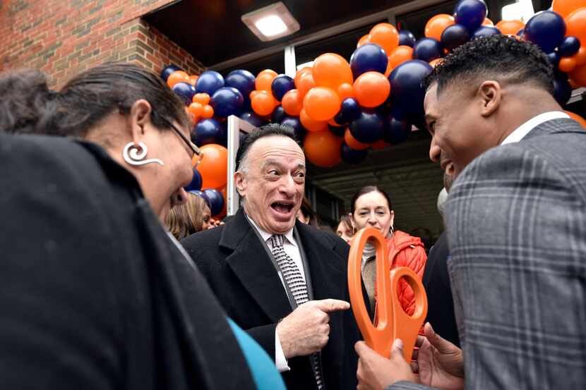 Tony Fleo (center), chief executive officer of Venture Partners Dallas, helps Kevin Lee with...