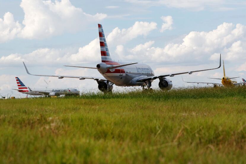 Airplanes taxi on the tarmac at DFW International Airport on Wednesday, August 23, 2017....