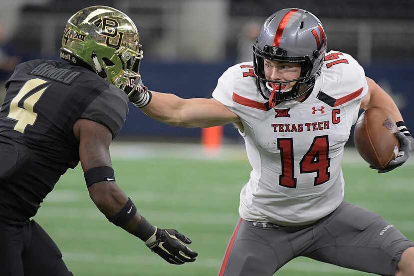 Texas Tech Red Raiders wide receiver Dylan Cantrell (14) stiff-arms Baylor Bears cornerback...