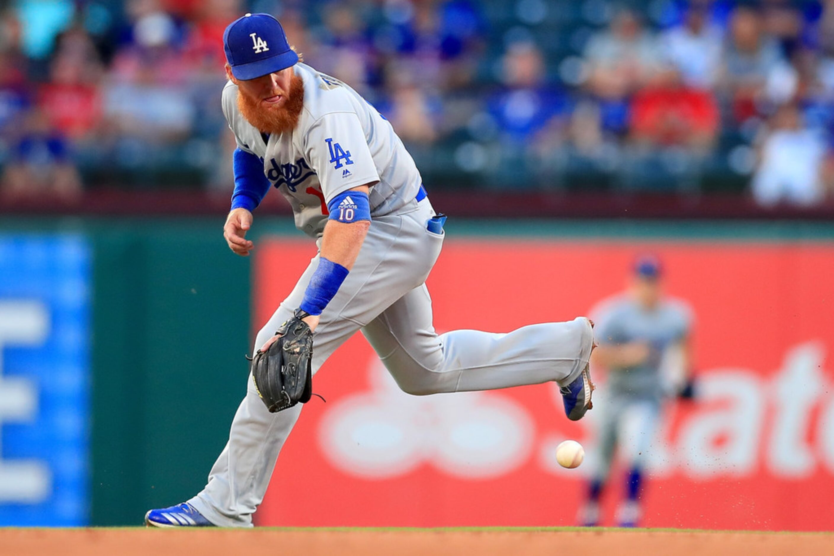 ARLINGTON, TX - AUGUST 28:  Justin Turner #10 of the Los Angeles Dodgers fields a ground...