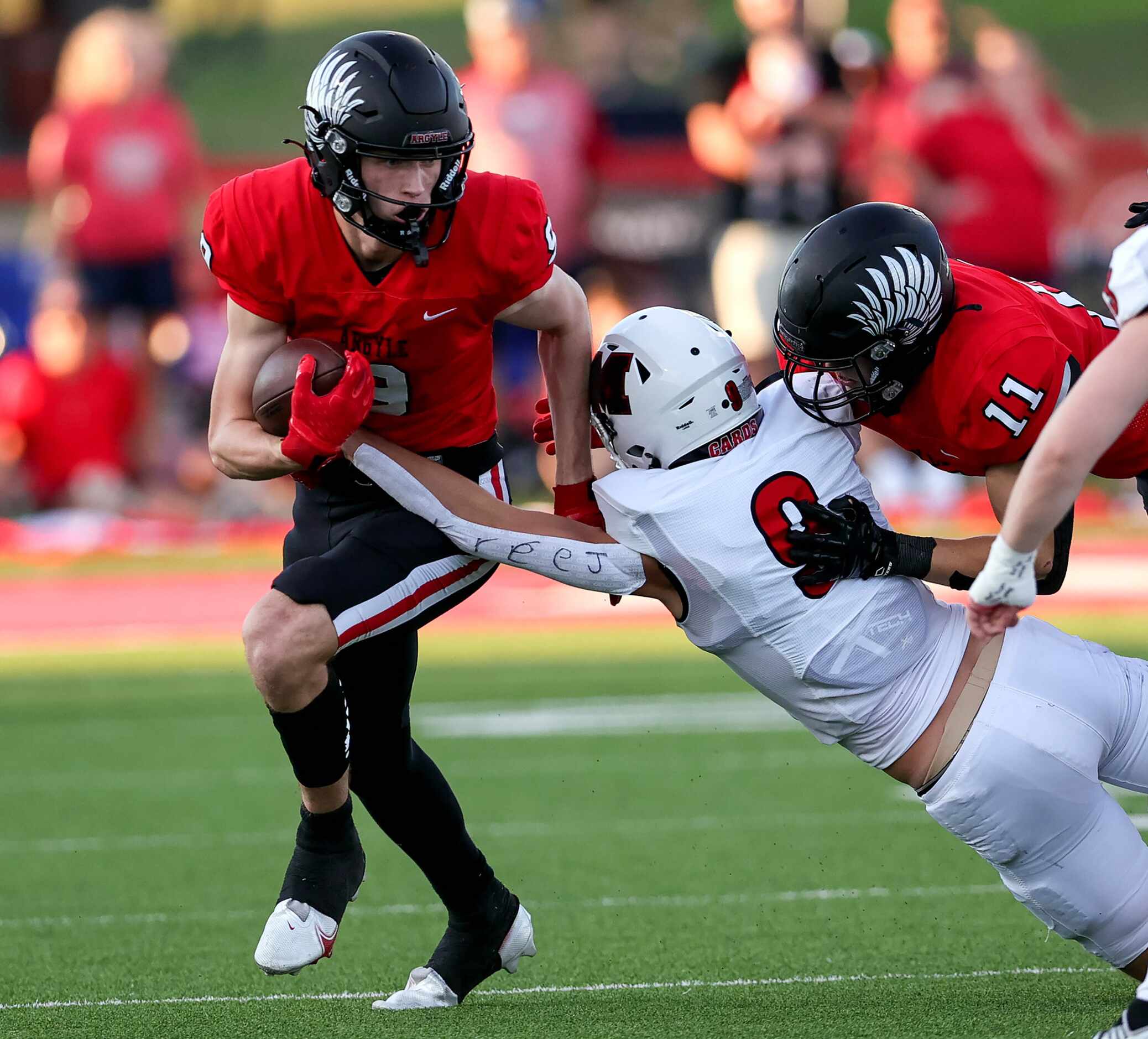 Argyle wide receiver Wayne Pritts (9) tries to break a tackle against Melissa's Karson...
