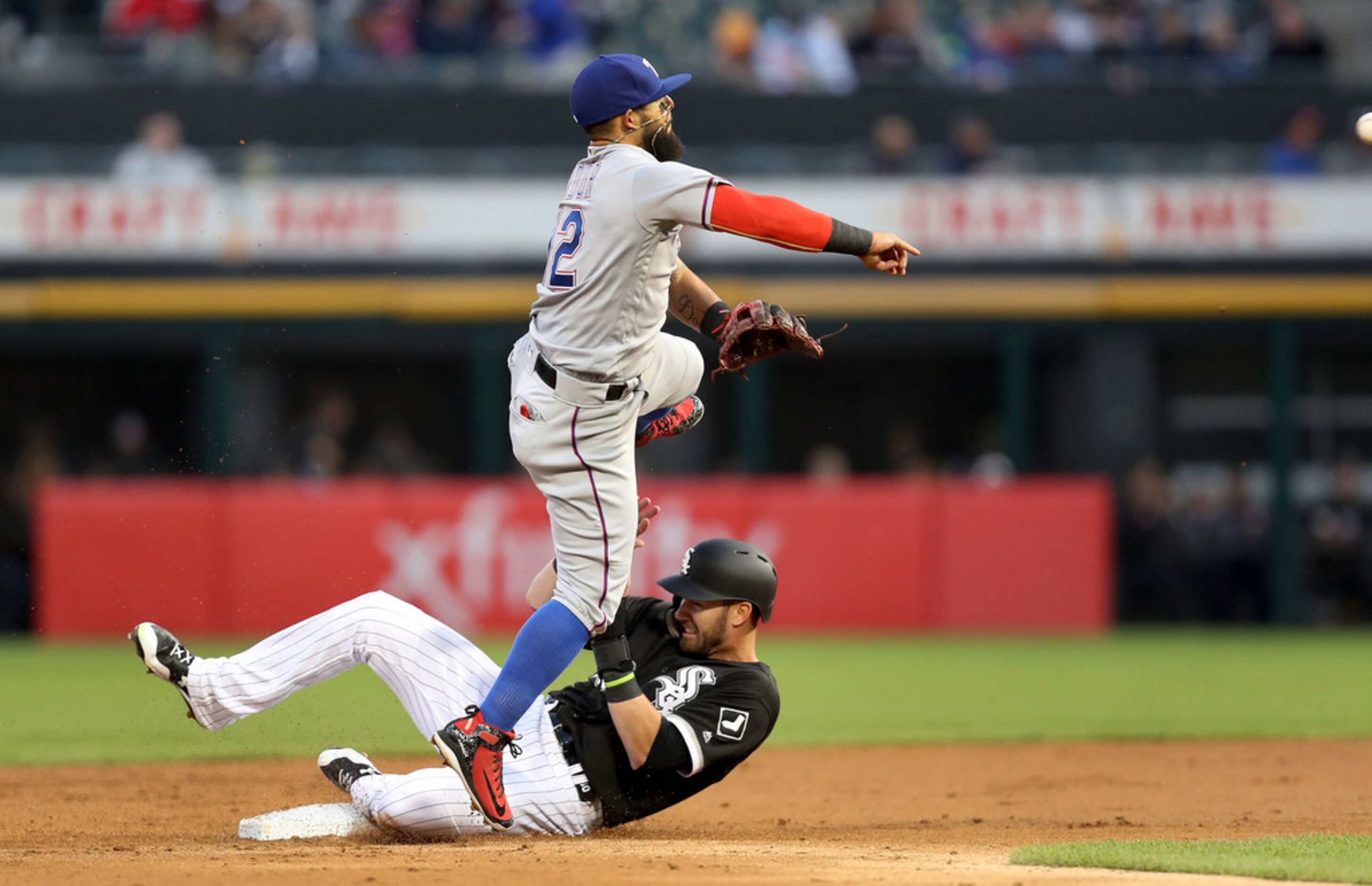 Chicago White Sox baserunner Nicky Delmonico is forced out at second base by Texas Rangers...