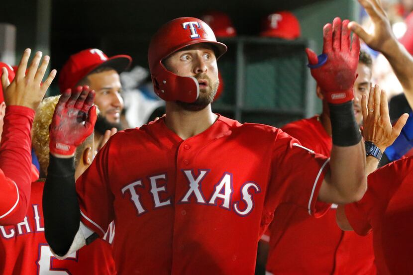 FILE - Texas Rangers left fielder Joey Gallo (13) is congratulated by teammates in the...